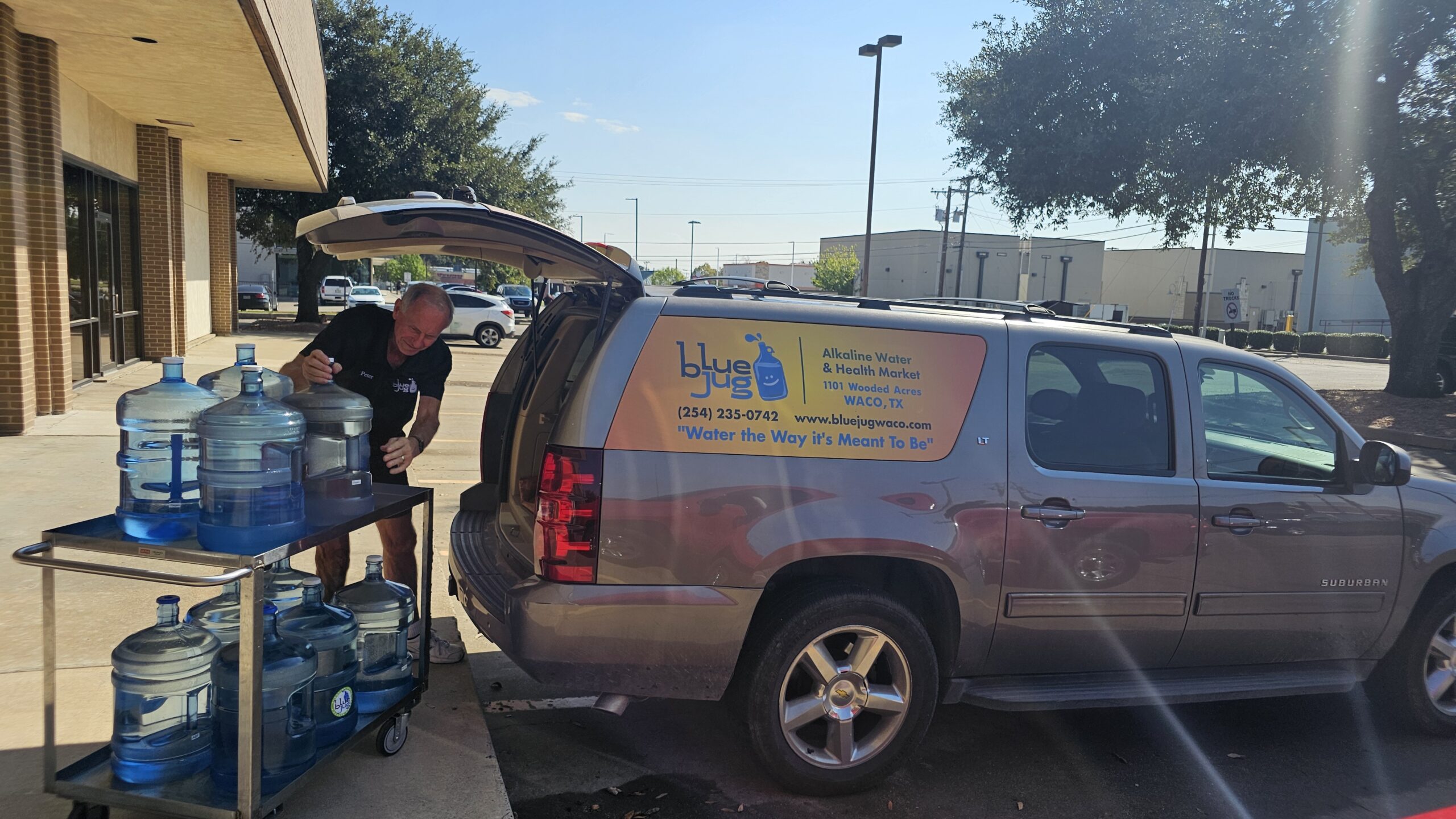 a man keeping water cans on his car